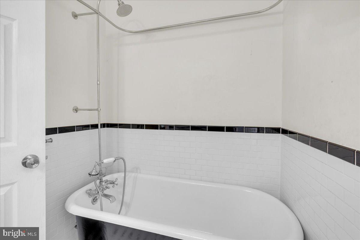 45 Broad Street Mount Holly, NJ 08060 - Photo 38 of 58 a bathroom with a bathtub and a sink