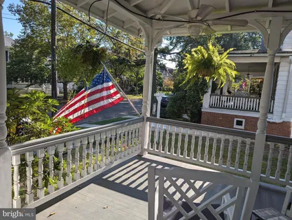 a front view of a house with garden and sitting area