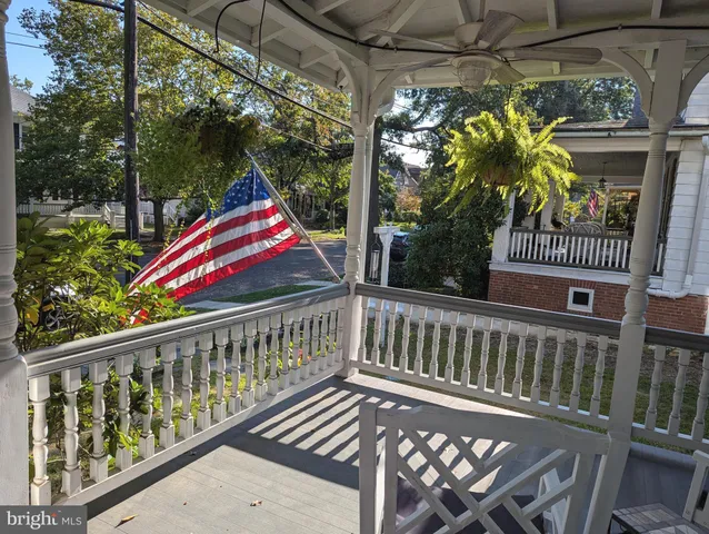 a front view of a house with garden and sitting area