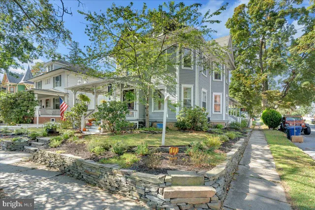a view of house with backyard and outdoor seating