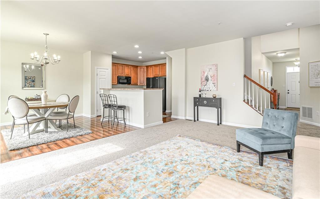 205 Broadstone Drive Mars, PA 16046 - Photo 6 of 24 a living room with furniture and a dining table with kitchen view