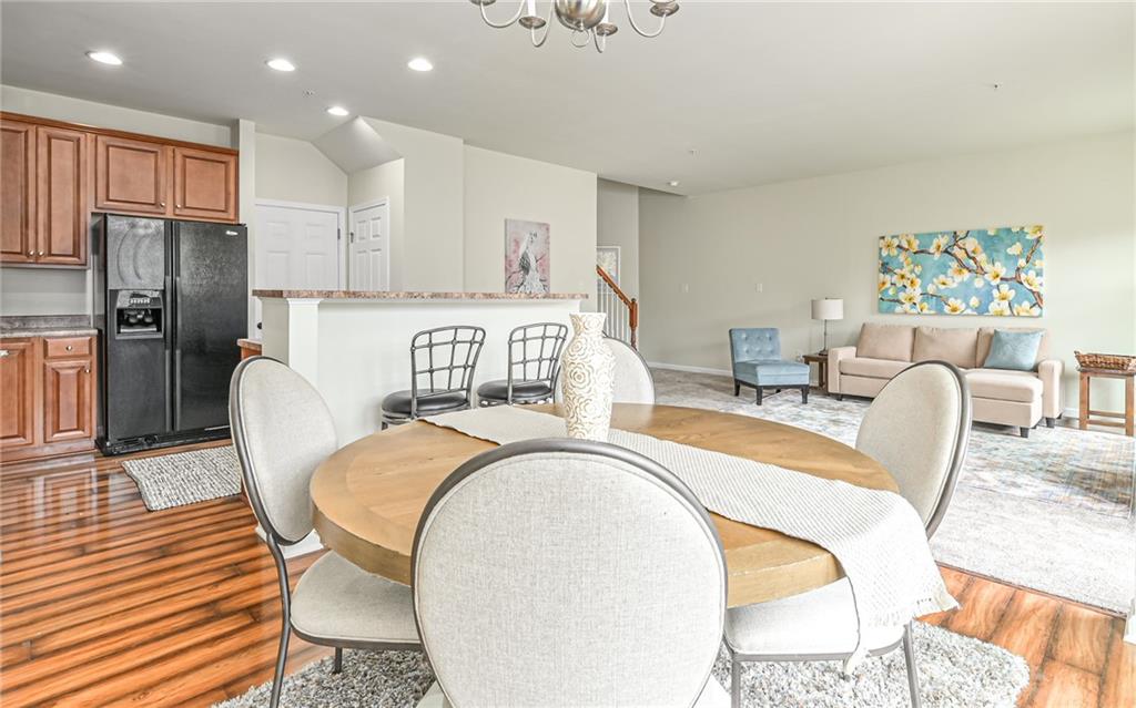 205 Broadstone Drive Mars, PA 16046 - Photo 8 of 24 a living room with furniture a refrigerator and kitchen view
