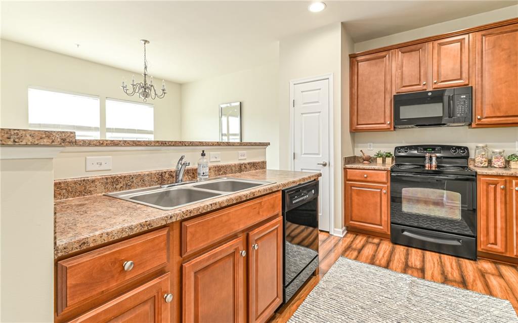 205 Broadstone Drive Mars, PA 16046 - Photo 9 of 24 a kitchen with stainless steel appliances granite countertop a sink stove and microwave