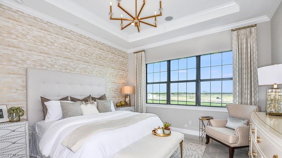 15335 Lucerna Street, Unit 201 Naples, FL 34114 - Photo 6 of 11 a spacious bedroom with a bed and a couch