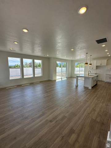 1225 West 500 South Logan, UT 84321 - Photo 11 of 39 Open concept living area featuring wood-finish flooring, recessed lighting, and multiple large windows