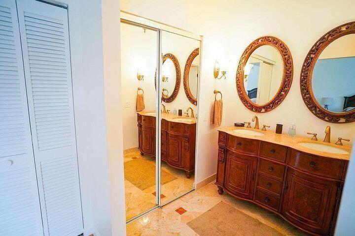 1511 Ocean Dunes Circle, Unit 1511 Jupiter, FL 33477 - Photo 17 of 27 a bathroom with a double vanity sink and a mirror