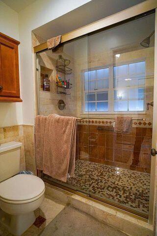 1511 Ocean Dunes Circle, Unit 1511 Jupiter, FL 33477 - Photo 19 of 27 a bathroom with a toilet and a shower