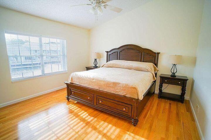 1511 Ocean Dunes Circle, Unit 1511 Jupiter, FL 33477 - Photo 20 of 27 a bedroom with a bed and wooden floor