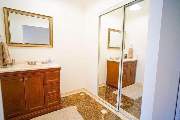 1511 Ocean Dunes Circle, Unit 1511 Jupiter, FL 33477 - Photo 21 of 27 a bathroom with a sink and a mirror