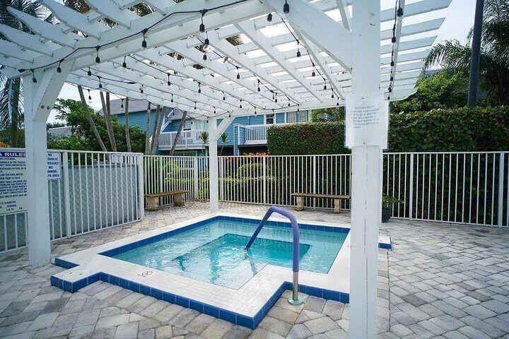 1511 Ocean Dunes Circle, Unit 1511 Jupiter, FL 33477 - Photo 23 of 27 a view of a chair and tables in the patio