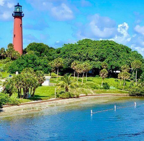 1511 Ocean Dunes Circle, Unit 1511 Jupiter, FL 33477 - Photo 26 of 27 a front view of a house with a yard and potted plants