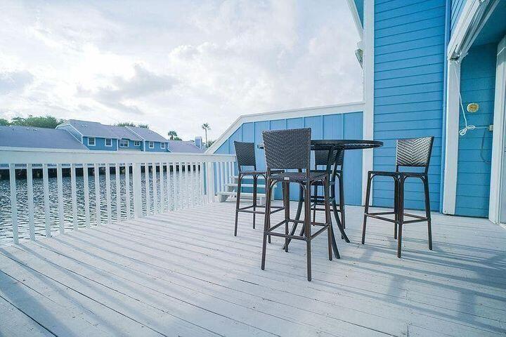 1511 Ocean Dunes Circle, Unit 1511 Jupiter, FL 33477 - Photo 3 of 27 a view of a roof deck with table and chairs a barbeque with wooden floor and fence