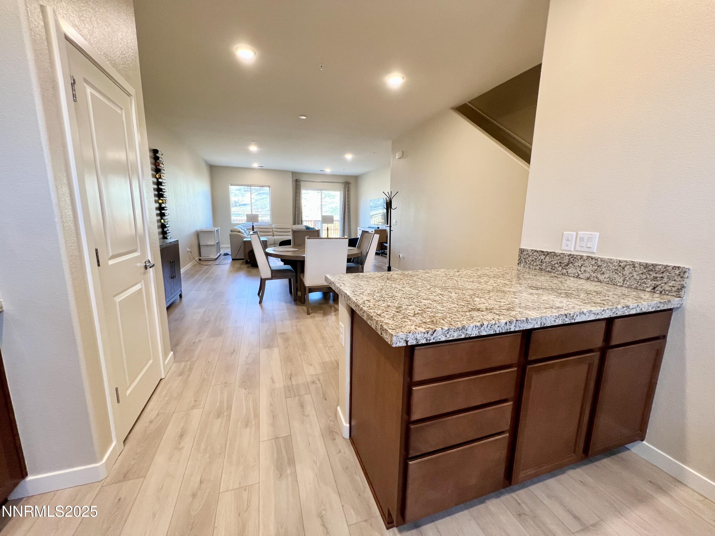 4969 Cavestone Road Sun Valley, NV 89433 - Photo 15 of 40 a view of living room with granite countertop furniture and wooden floor