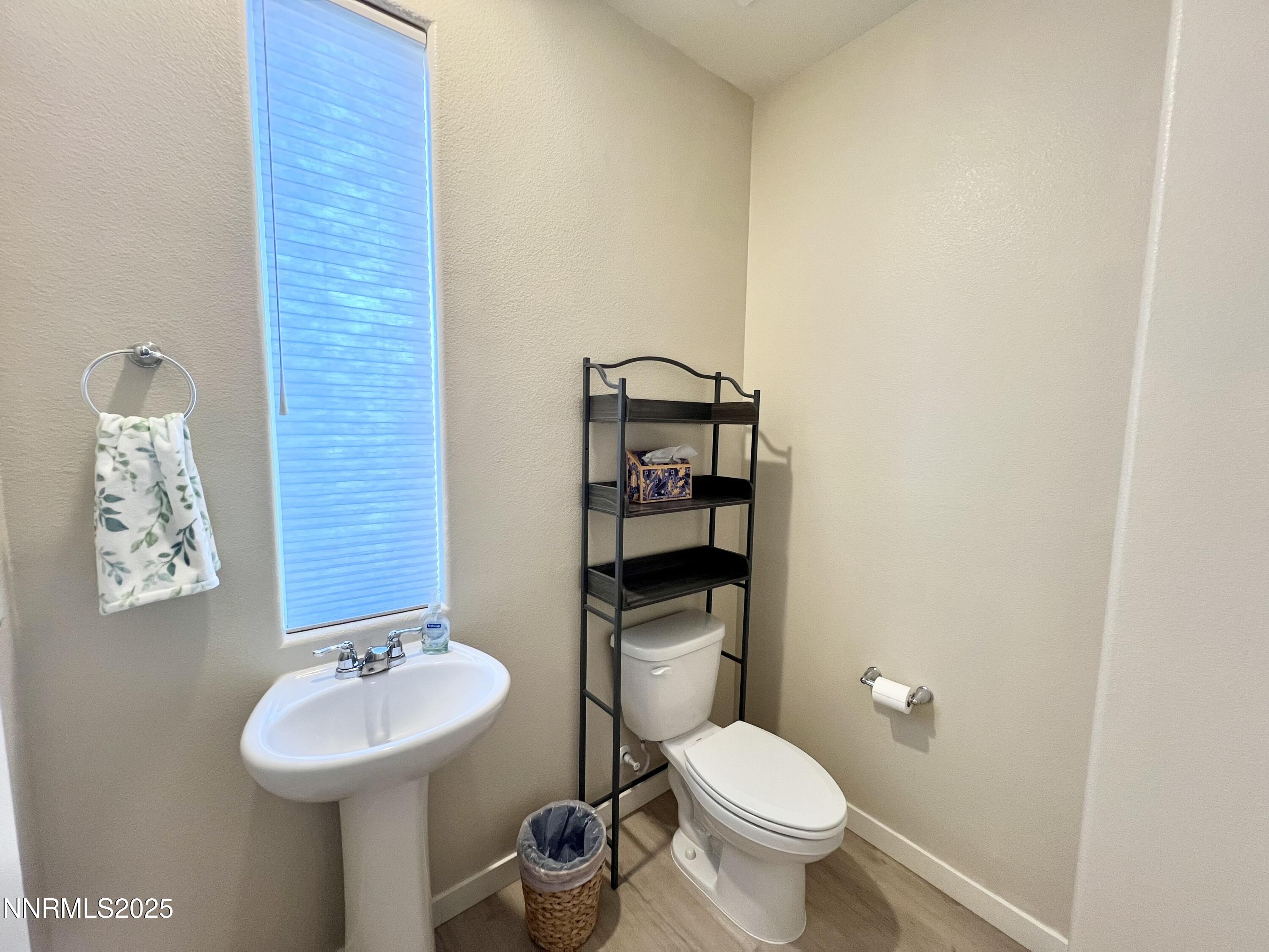 4969 Cavestone Road Sun Valley, NV 89433 - Photo 17 of 40 a bathroom with a toilet sink and mirror