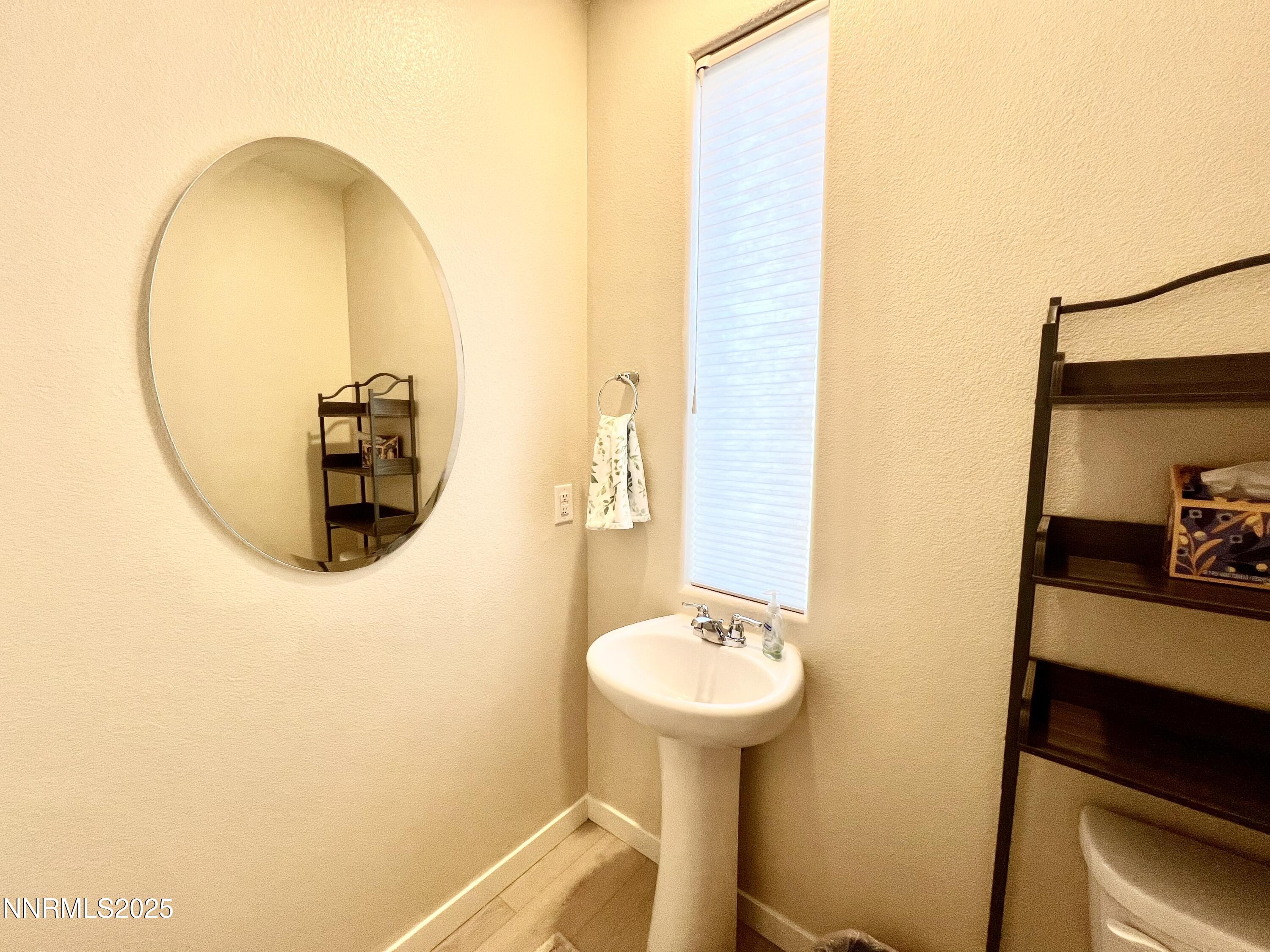 4969 Cavestone Road Sun Valley, NV 89433 - Photo 18 of 40 a bathroom with a sink and a mirror