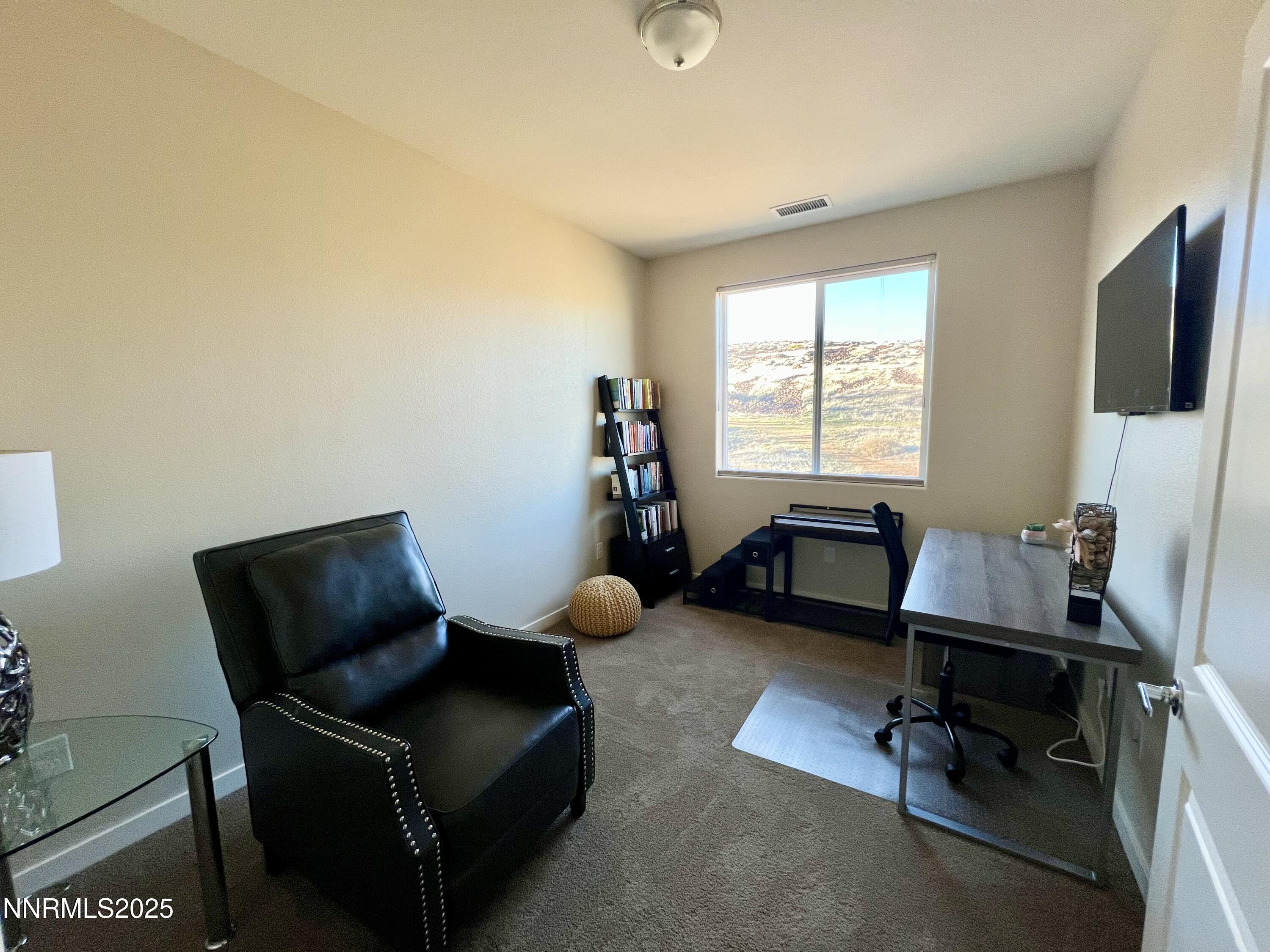 4969 Cavestone Road Sun Valley, NV 89433 - Photo 20 of 40 a living room with furniture and a flat screen tv