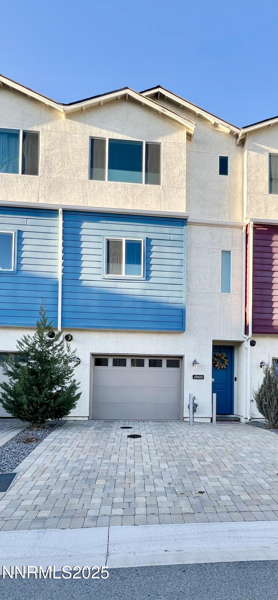 4969 Cavestone Road Sun Valley, NV 89433 - Photo 2 of 40 a view of a house with a yard and a garage