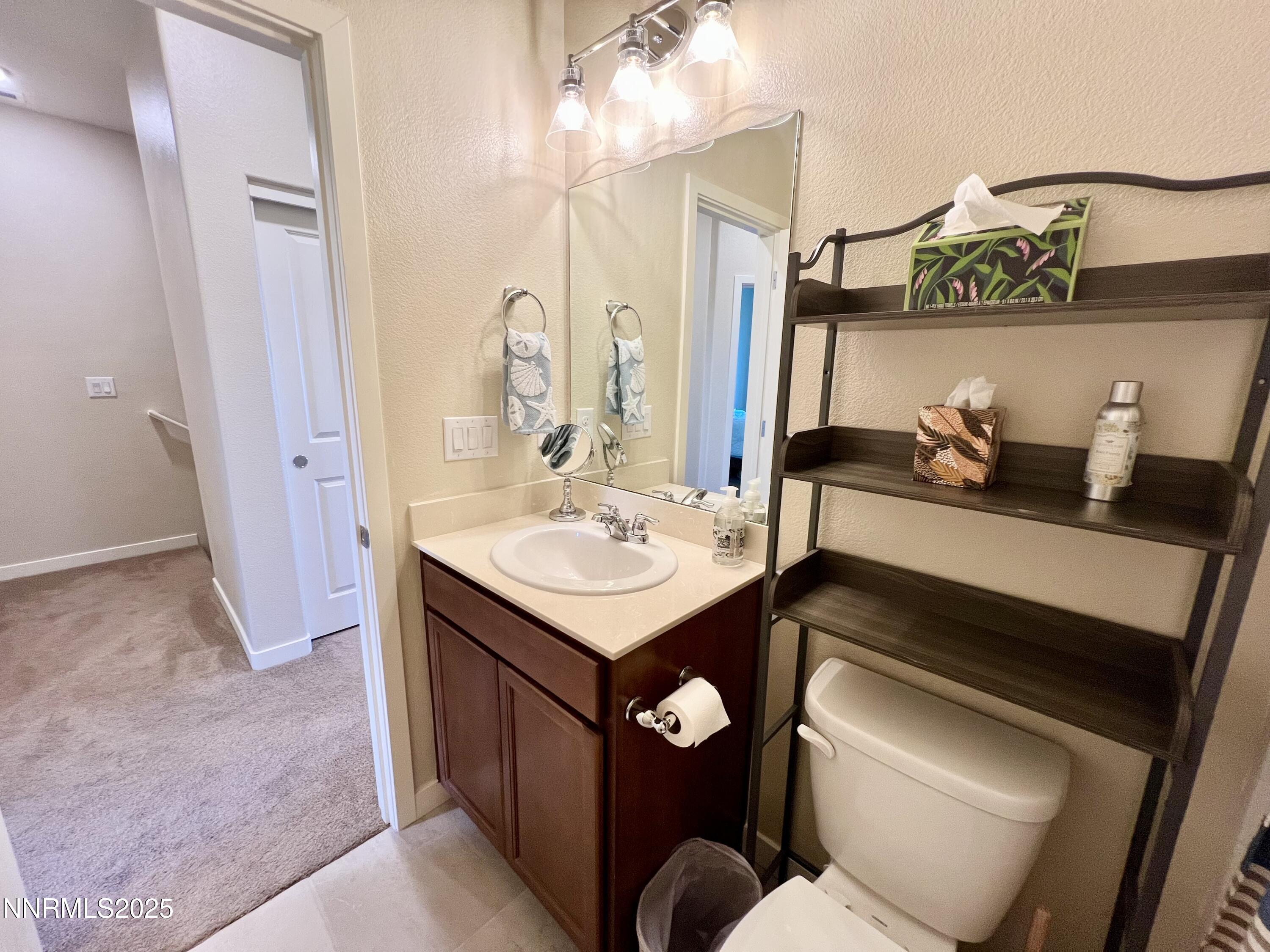 4969 Cavestone Road Sun Valley, NV 89433 - Photo 29 of 40 a bathroom with a sink and a mirror