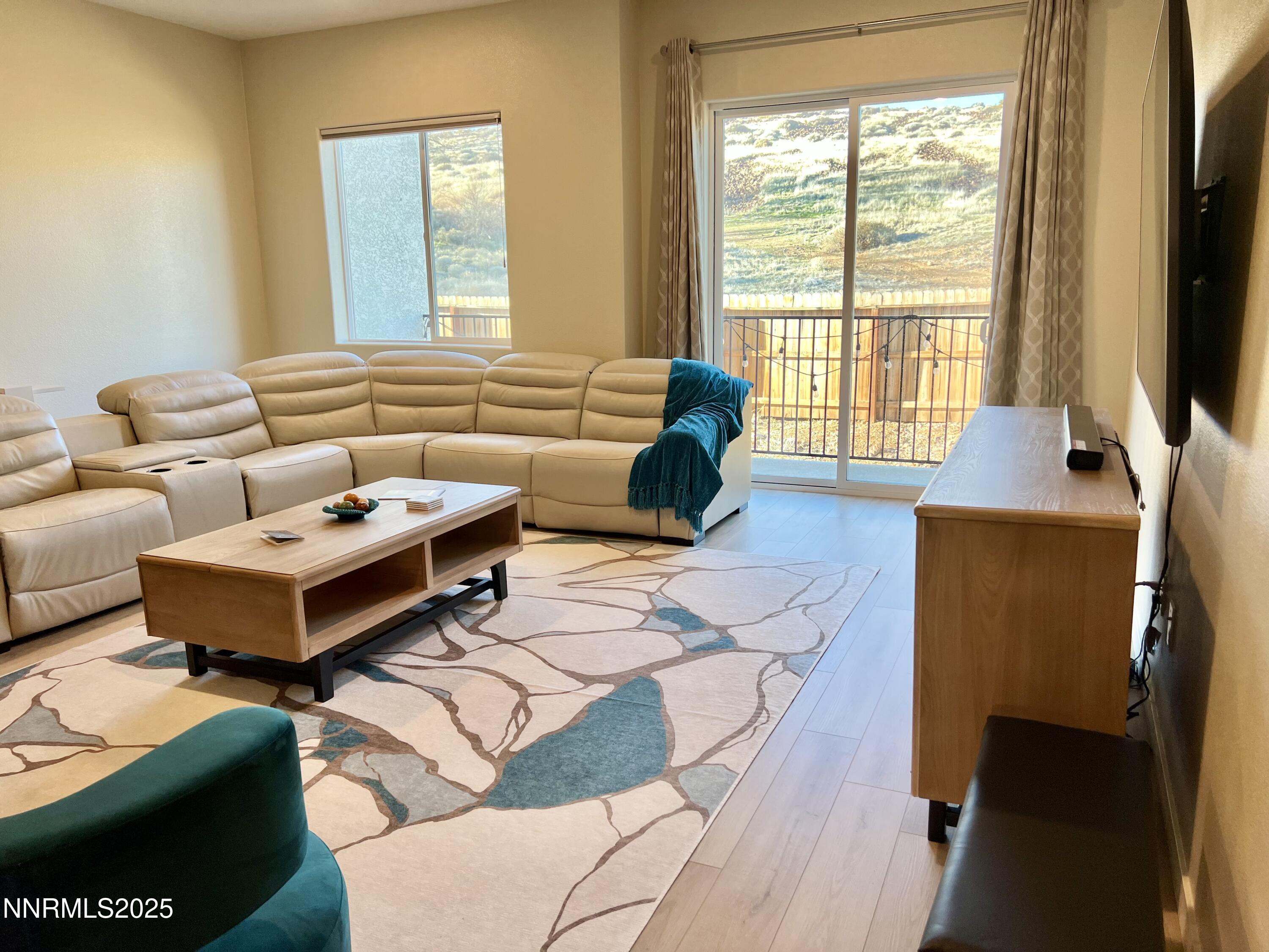 4969 Cavestone Road Sun Valley, NV 89433 - Photo 3 of 40 a living room with furniture and a flat screen tv