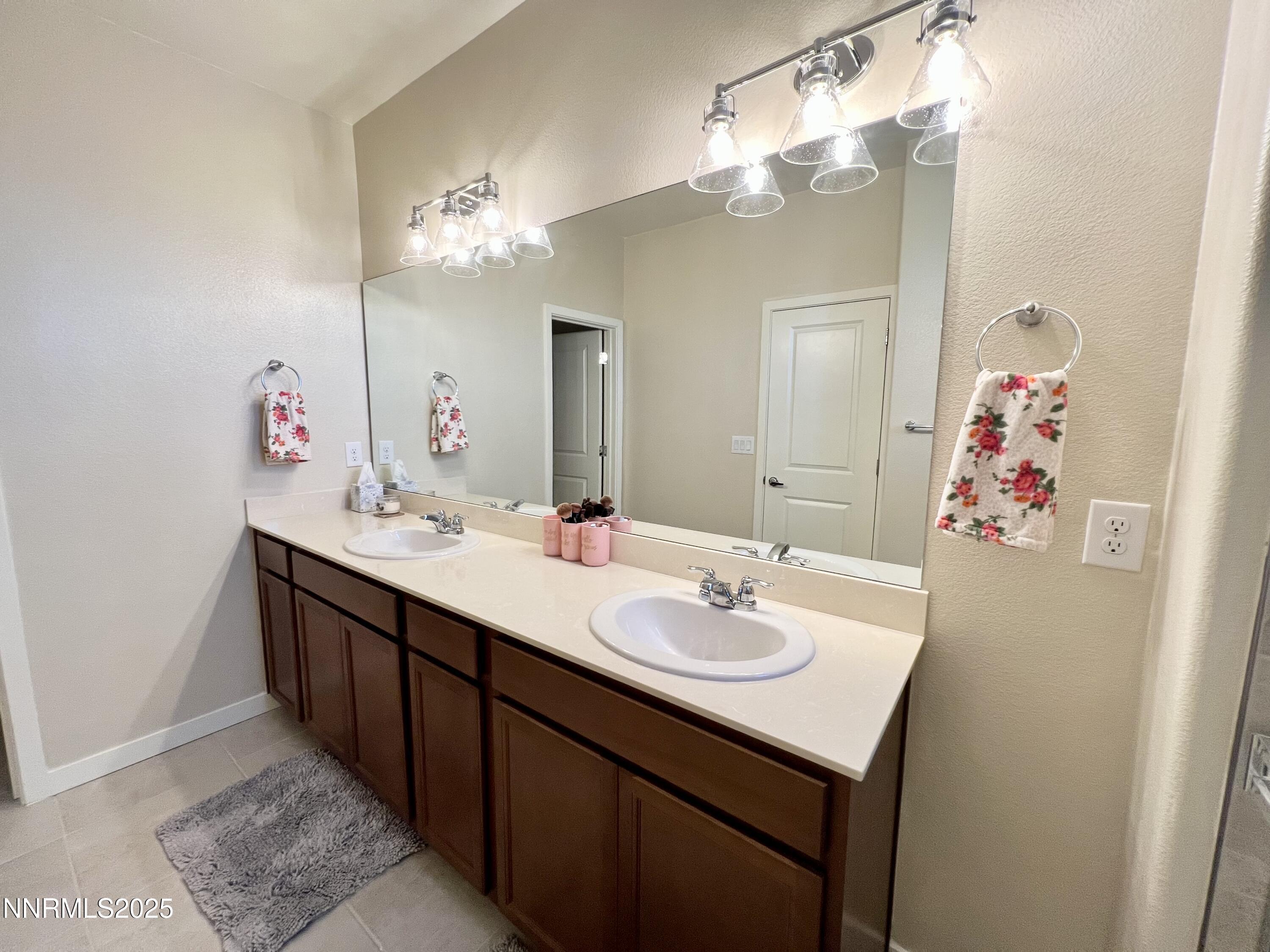4969 Cavestone Road Sun Valley, NV 89433 - Photo 37 of 40 a bathroom with a sink vanity and a mirror