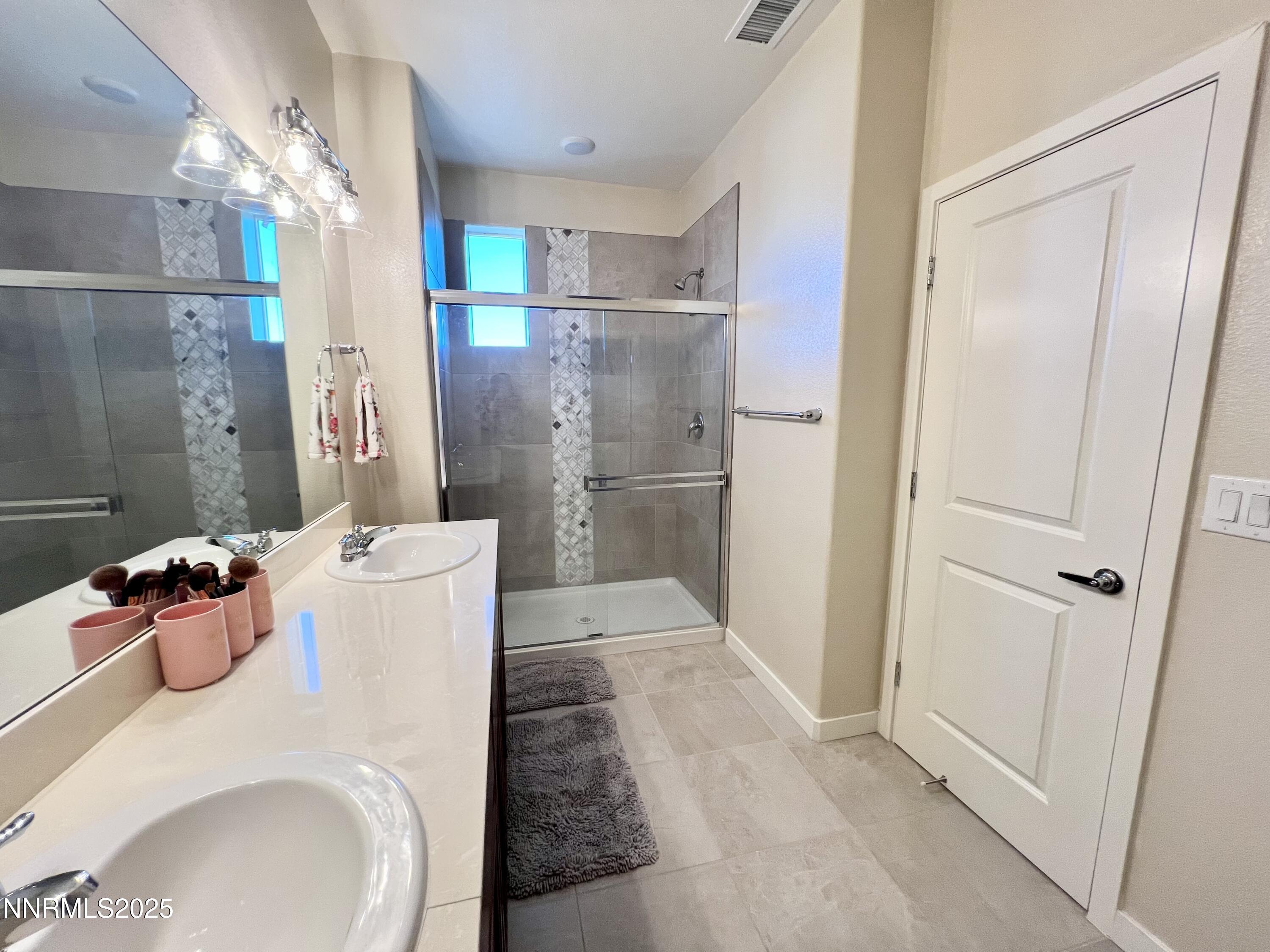 4969 Cavestone Road Sun Valley, NV 89433 - Photo 38 of 40 a bathroom with a sink and a shower
