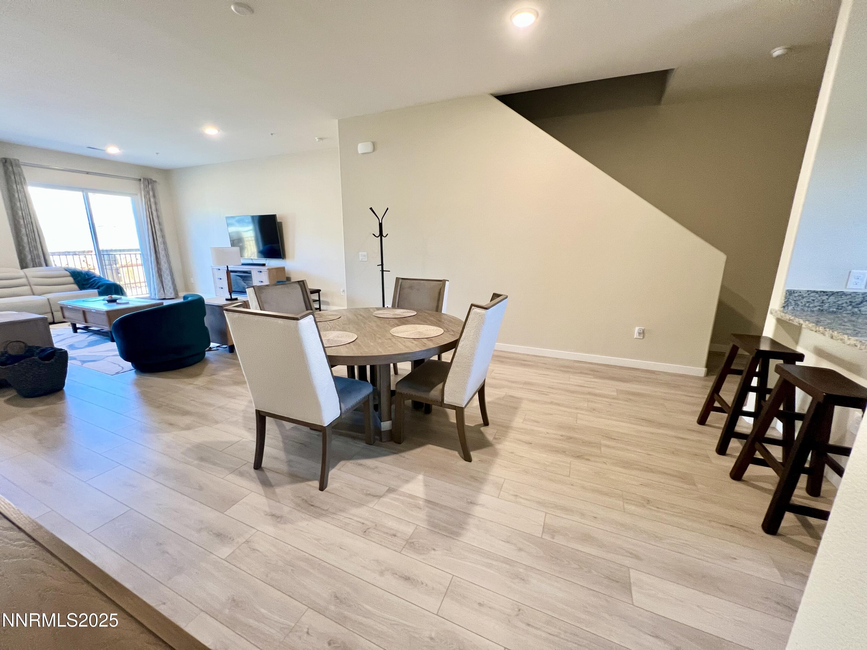 4969 Cavestone Road Sun Valley, NV 89433 - Photo 8 of 40 a view of a dining room with furniture and wooden floor