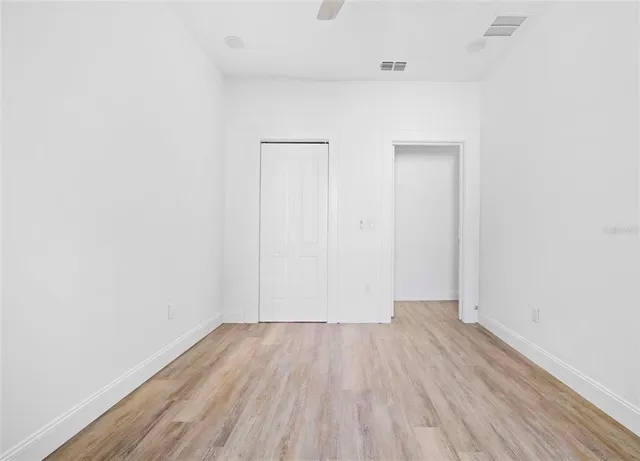a view of a room with wooden floor