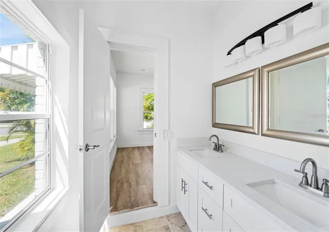 a bathroom with a double vanity sink and a mirror