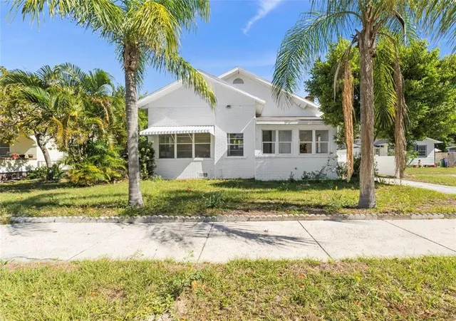 a view of a yard in front of a house with a fountain
