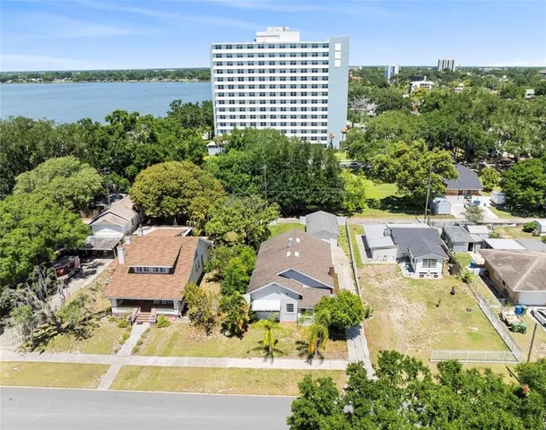 an aerial view of a residential houses with outdoor space and street view