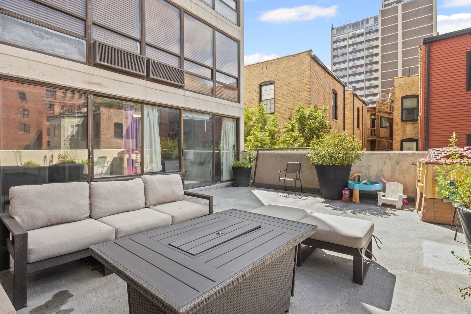 3150 North Sheridan Road, Unit 2C Chicago, IL 60657 - Photo 12 of 25 a view of a patio with couches and a potted plant on a table