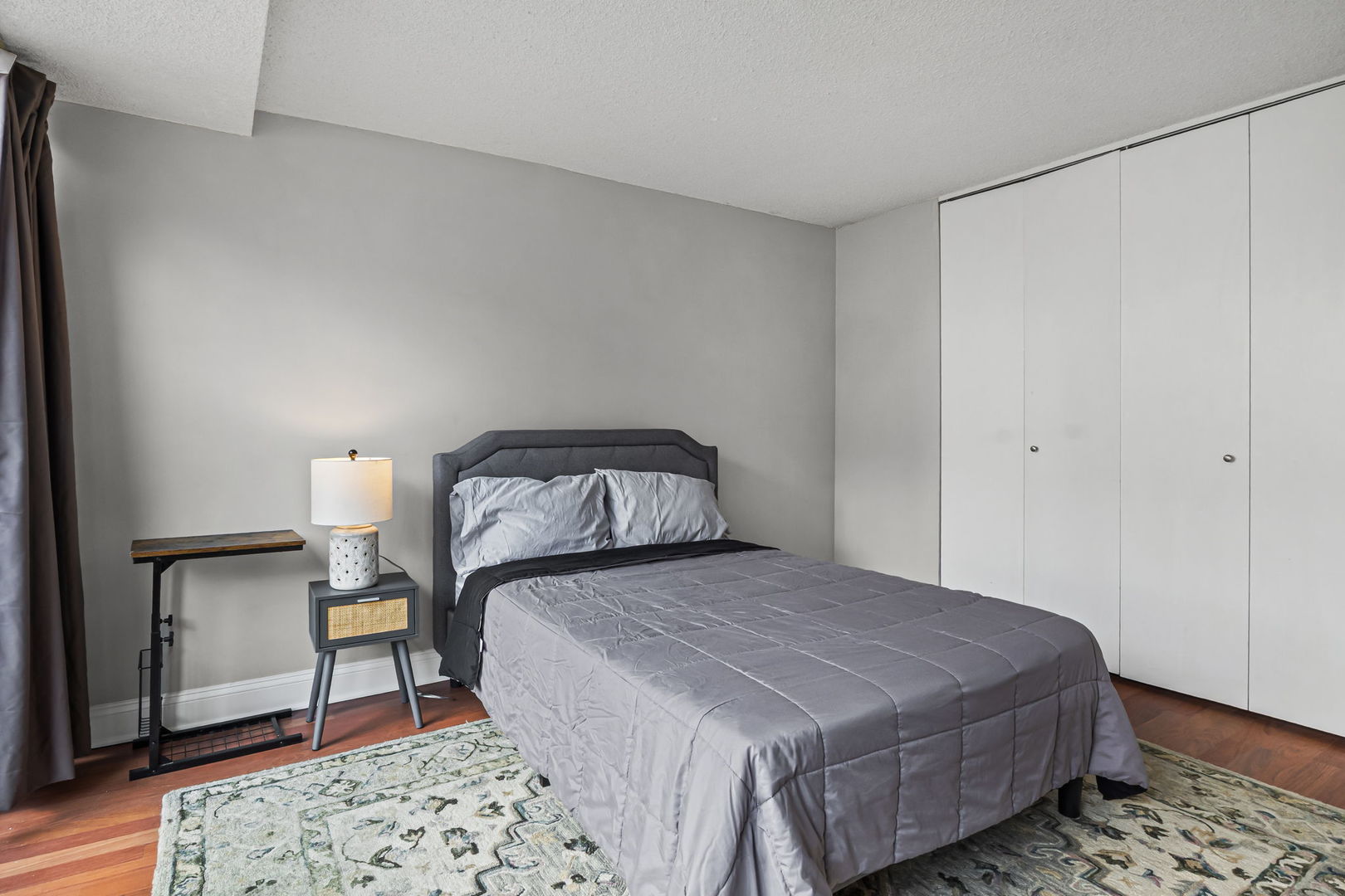 3150 North Sheridan Road, Unit 2C Chicago, IL 60657 - Photo 19 of 25 a bedroom with a bed and wooden floor