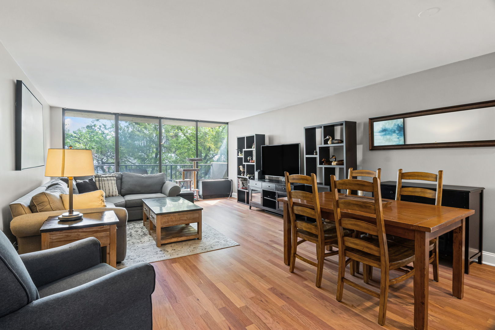 3150 North Sheridan Road, Unit 2C Chicago, IL 60657 - Photo 3 of 25 a living room with furniture a flat screen tv and a large window