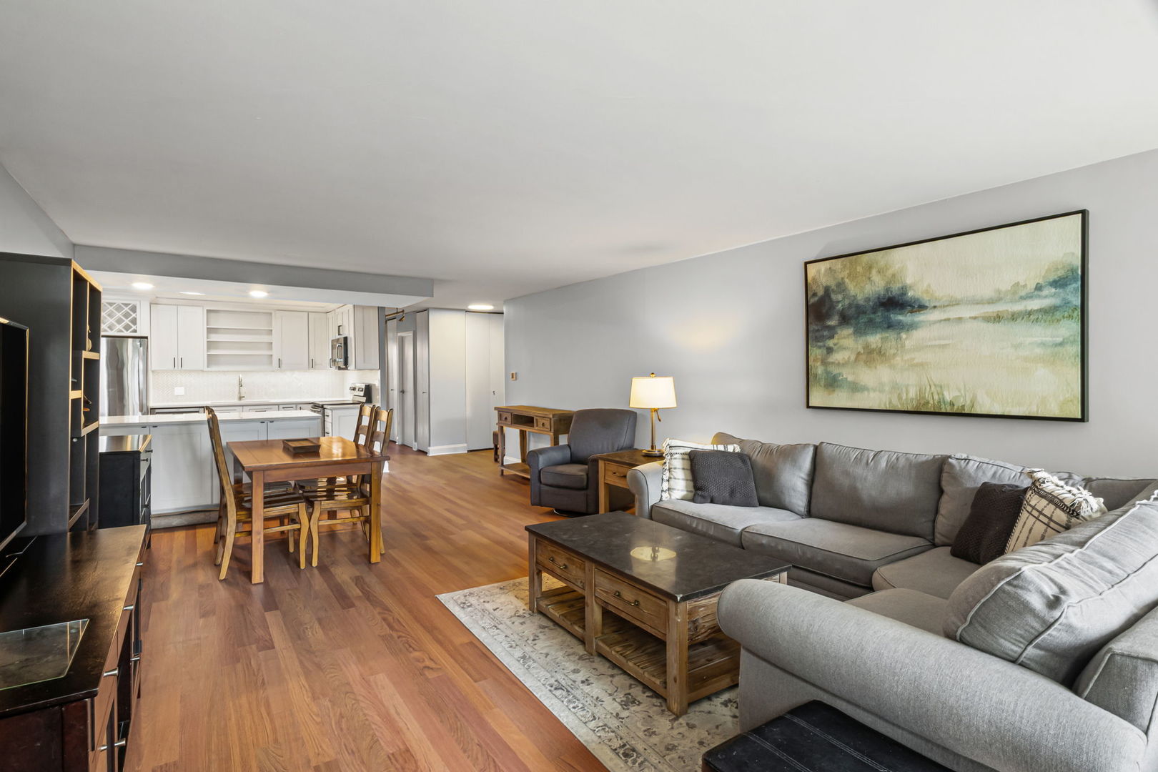 3150 North Sheridan Road, Unit 2C Chicago, IL 60657 - Photo 6 of 25 a living room with furniture wooden floor and a flat screen tv