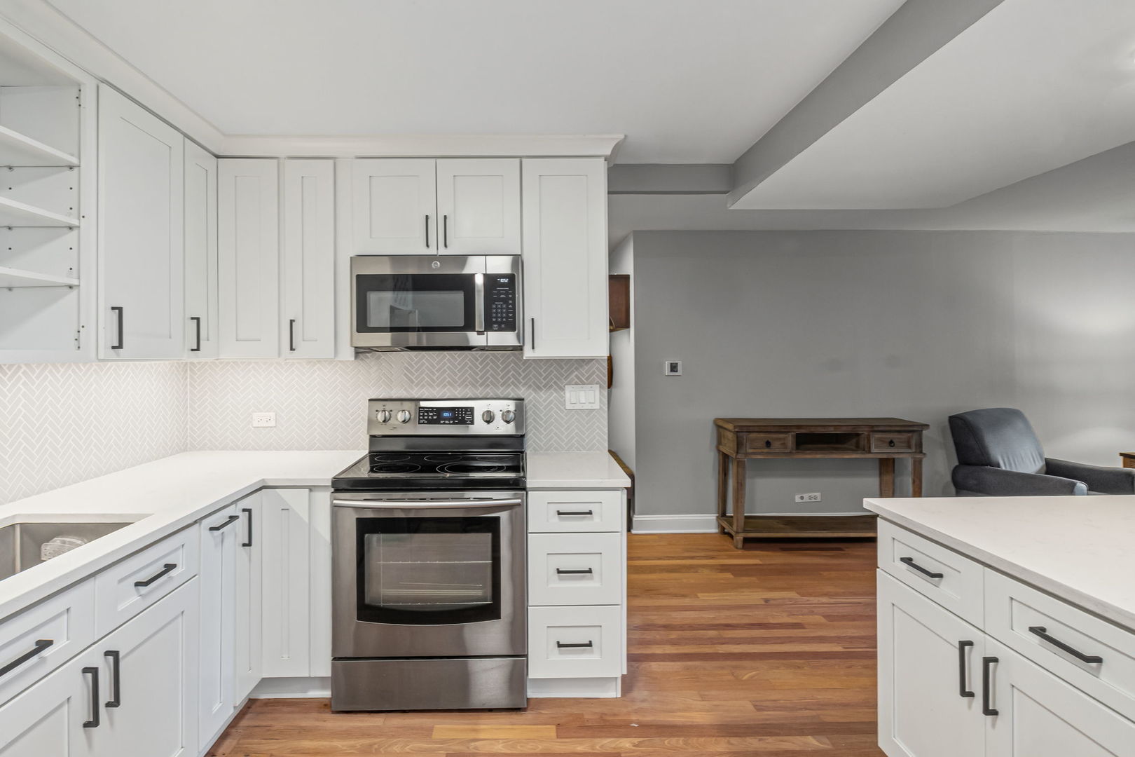 3150 North Sheridan Road, Unit 2C Chicago, IL 60657 - Photo 10 of 25 a kitchen with cabinets stainless steel appliances and wooden floor