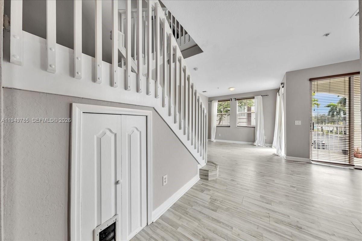 4341 Southwest 160th Avenue, Unit 201 Miramar, FL 33027 - Photo 13 of 53 a view of staircase with wooden floor and white walls
