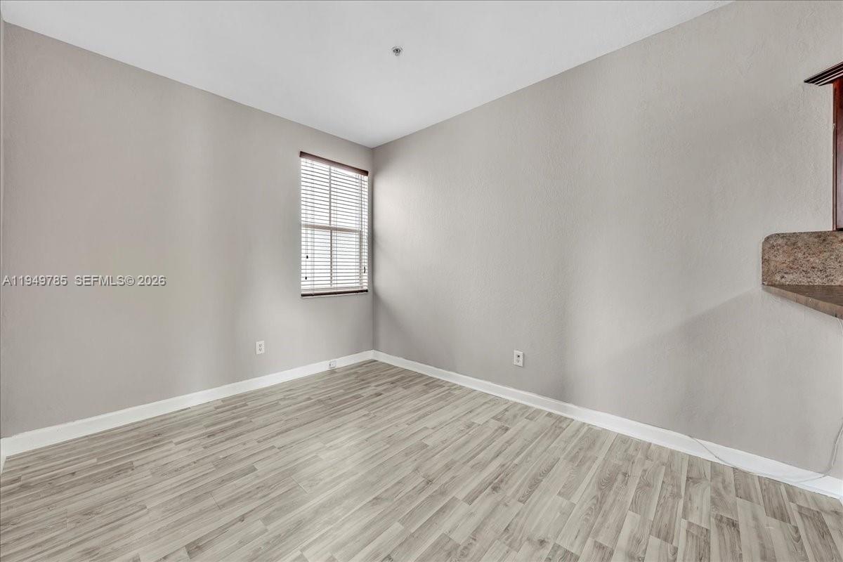 4341 Southwest 160th Avenue, Unit 201 Miramar, FL 33027 - Photo 16 of 53 wooden floor in an empty room with a window