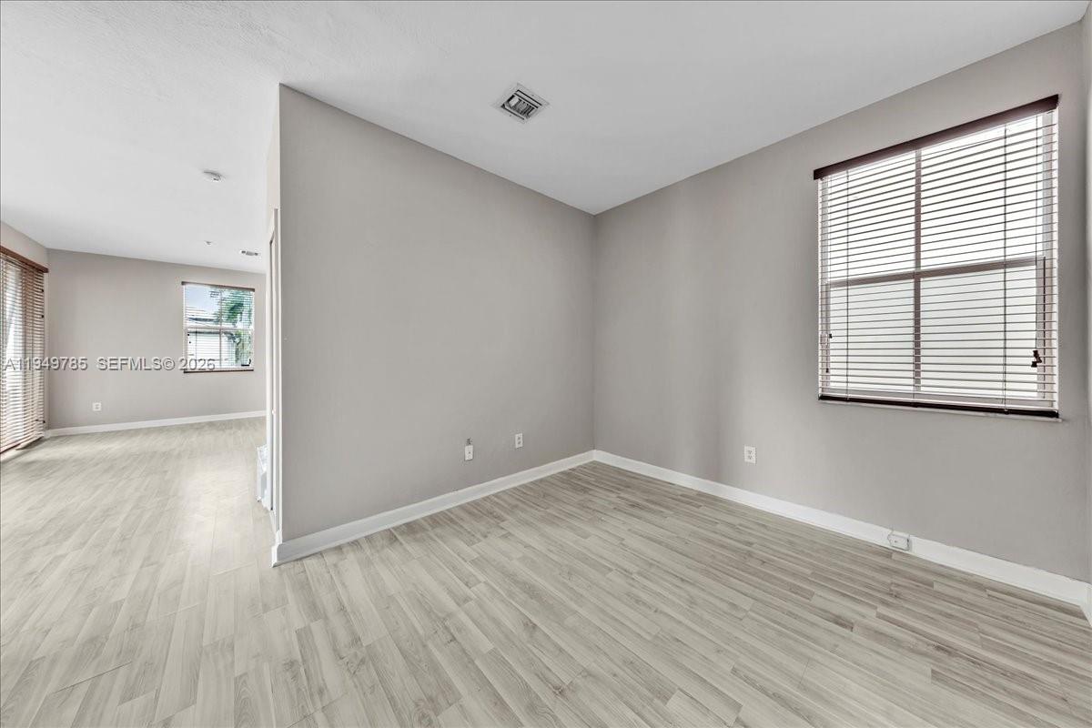 4341 Southwest 160th Avenue, Unit 201 Miramar, FL 33027 - Photo 17 of 53 wooden floor in an empty room with a window