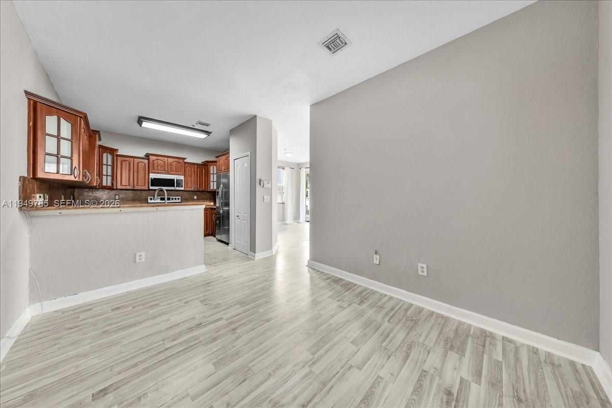 4341 Southwest 160th Avenue, Unit 201 Miramar, FL 33027 - Photo 18 of 53 a view of a kitchen with wooden floor and a kitchen