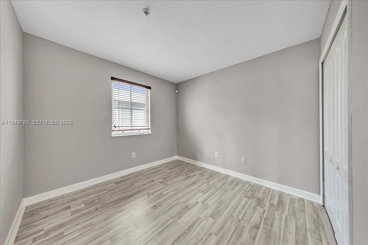 4341 Southwest 160th Avenue, Unit 201 Miramar, FL 33027 - Photo 26 of 53 wooden floor in an empty room with a window
