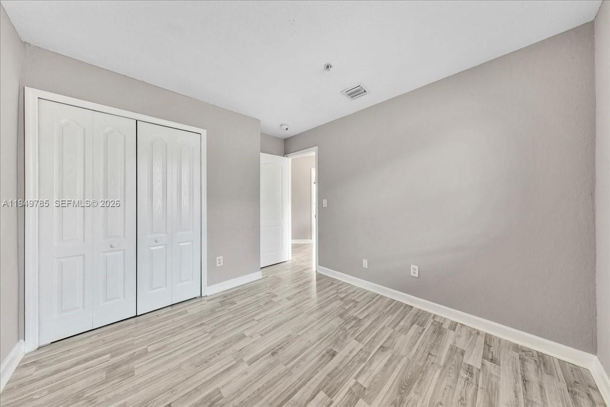 4341 Southwest 160th Avenue, Unit 201 Miramar, FL 33027 - Photo 28 of 53 a view of an empty room with wooden floor