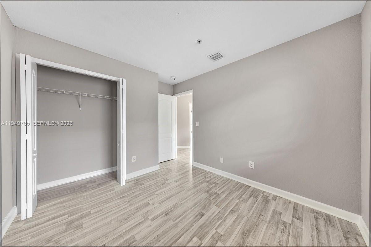 4341 Southwest 160th Avenue, Unit 201 Miramar, FL 33027 - Photo 29 of 53 a view of an empty room with wooden floor