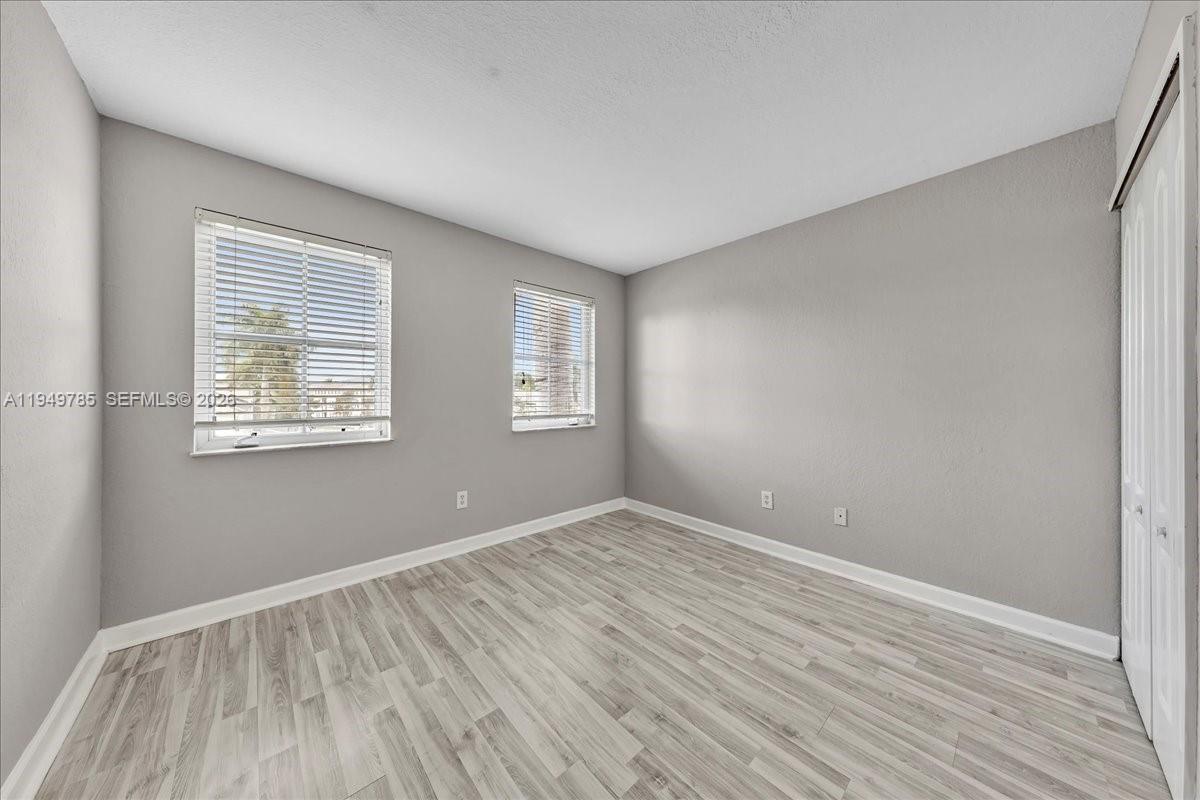 4341 Southwest 160th Avenue, Unit 201 Miramar, FL 33027 - Photo 30 of 53 wooden floor in an empty room with a window
