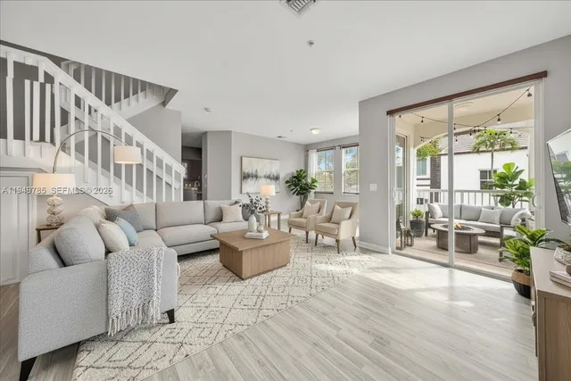 a living room with furniture and wooden floor