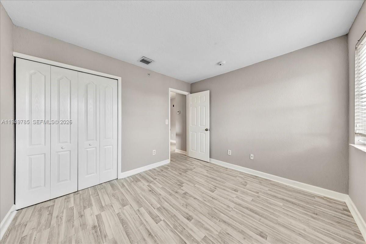 4341 Southwest 160th Avenue, Unit 201 Miramar, FL 33027 - Photo 32 of 53 a view of an empty room with wooden floor