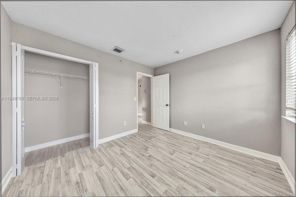 4341 Southwest 160th Avenue, Unit 201 Miramar, FL 33027 - Photo 33 of 53 a view of an empty room with wooden floor