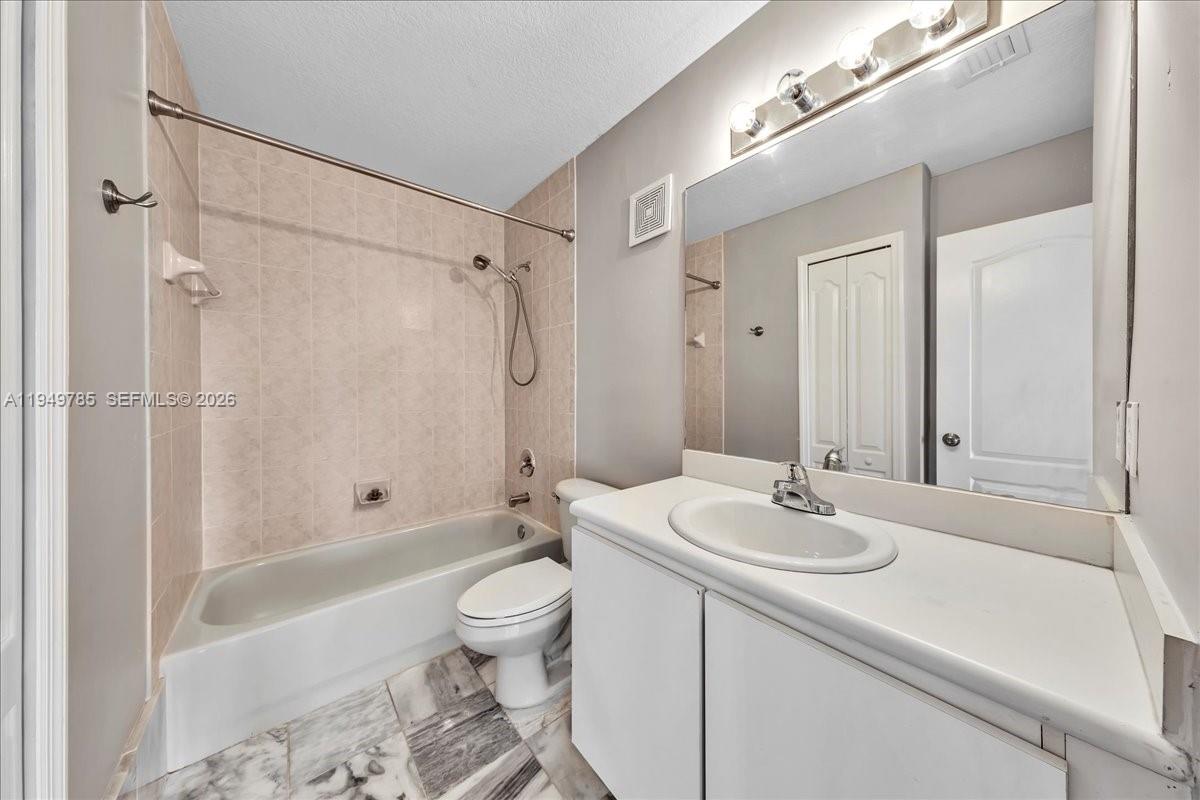 4341 Southwest 160th Avenue, Unit 201 Miramar, FL 33027 - Photo 34 of 53 a bathroom with a sink a toilet and shower