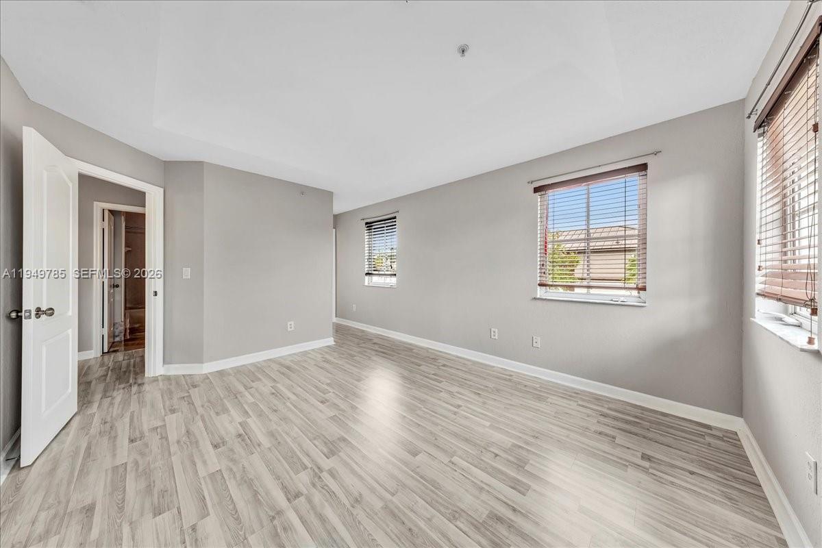 4341 Southwest 160th Avenue, Unit 201 Miramar, FL 33027 - Photo 36 of 53 a view of an empty room with wooden floor and a window