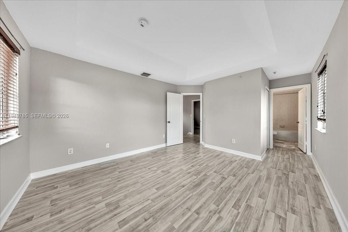 4341 Southwest 160th Avenue, Unit 201 Miramar, FL 33027 - Photo 37 of 53 wooden floor in an empty room with a window