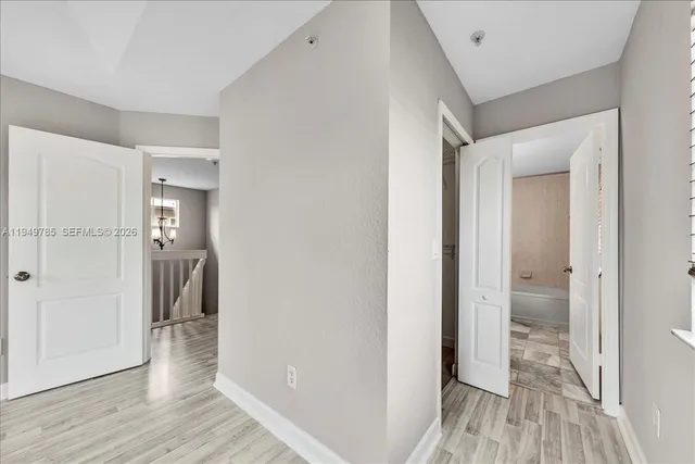 a view of hallway with wooden floor